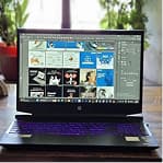 Laptop displaying a creative workspace with design projects on the screen