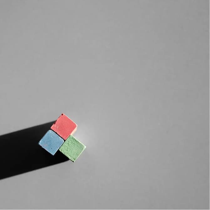 Team members collaborating in a modern office, discussing ideas at a whiteboard.